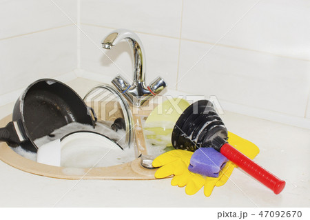huge heap of dirty dishes waiting for the flatmate 47092670