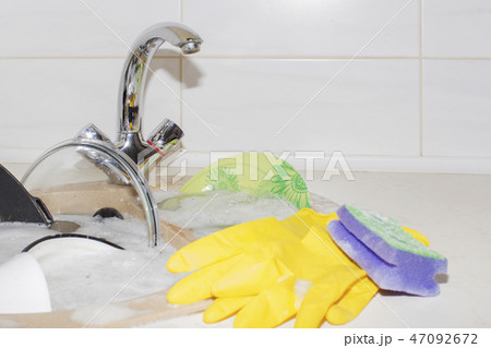 huge heap of dirty dishes waiting for the flatmate 47092672