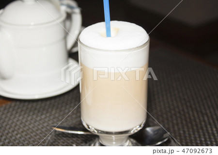 On the table is the tea Cup and kettle 47092673