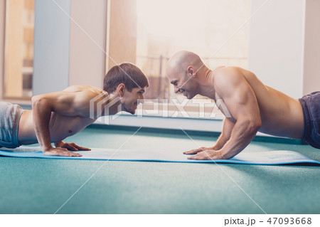 Two men will perform fitness training in the gym Two men will perform fitness training in the gym 47093668