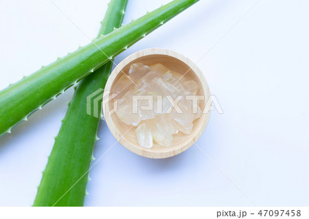 Aloe vera gel in wooden bowl on white 47097458