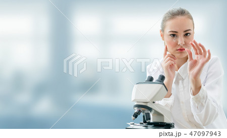Scientist researcher uses microscope in laboratory 47097943