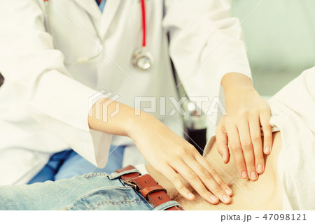 Woman Doctor and Male Patient in Hospital Office 47098121