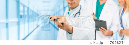 Doctor working in hospital with other doctors. 47098254