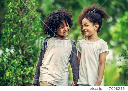 Happy little boy and girl in the park. Happy little boy and girl in the park. 47098256