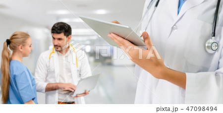 Doctor working in hospital with other doctors. Doctor working in hospital with other doctors. 47098494