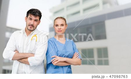 Doctors at hospital working with another doctor. Doctors at hospital working with another doctor. 47098763