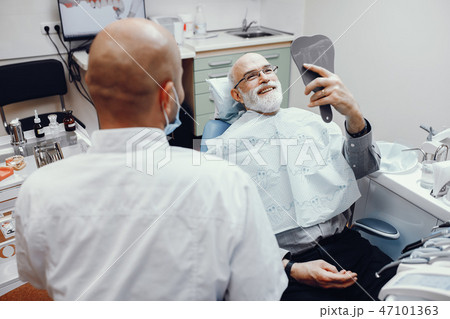 Old man sitting in the dentist's office Old man sitting in the dentist's office 47101363