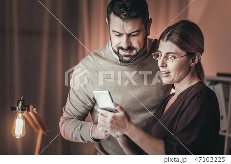 Pleasant two colleagues synchronizing agendas Pleasant two colleagues synchronizing agendas 47103225