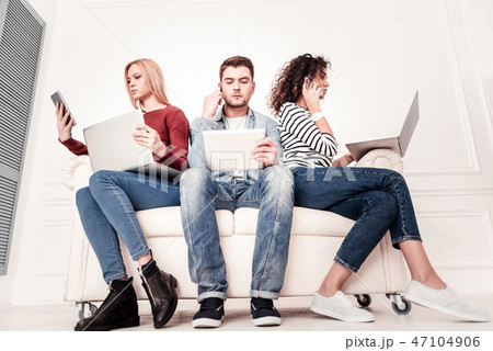 Smart serious people using modern gadgets 47104906