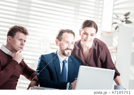 Glad three colleagues conducting meeting Glad three colleagues conducting meeting 47105751