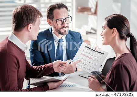 Joyful three colleagues arranging conference Joyful three colleagues arranging conference 47105808