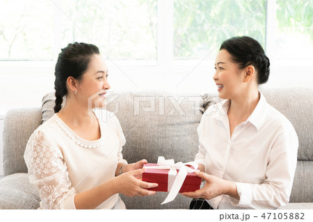 Women holding a gift box for special day  47105882