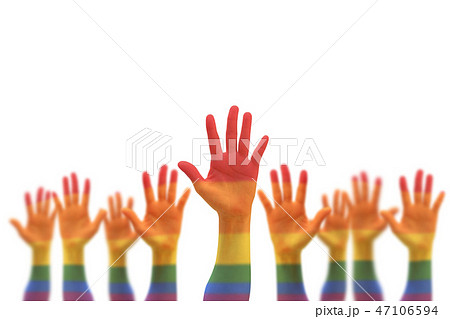 Rainbow multi-color flag on blur many people hands Rainbow multi-color flag on blur many people hands 47106594