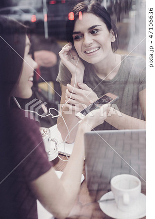 Cheerful brunette female looking at her friend Cheerful brunette female looking at her friend 47106636
