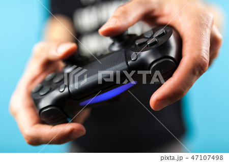 Male hands holding a gaming controller 47107498