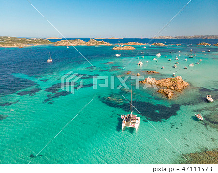 Drone aerial view of catamaran sailing boat in Maddalena Archipelago, Sardinia, Italy. 47111573