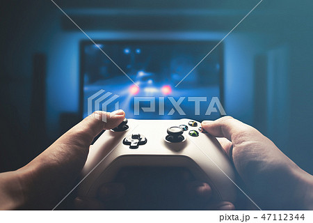 Video gaming console. Man playing car racing 47112344