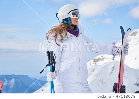 Portrait of beautiful woman with ski and ski suit in winter moun Portrait of beautiful woman with ski and ski suit in winter moun 47113078