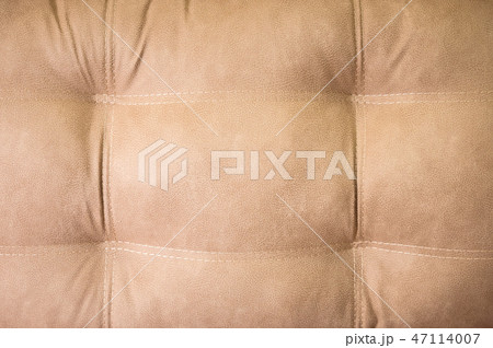 A close-up of a fragment of an expensive beige textile sofa in the room 47114007