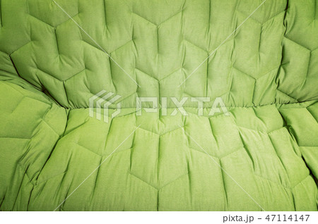 Close-up comfortable green soft sofa with curly stitching. Modern design Close-up comfortable green soft sofa with curly stitching. Modern design 47114147