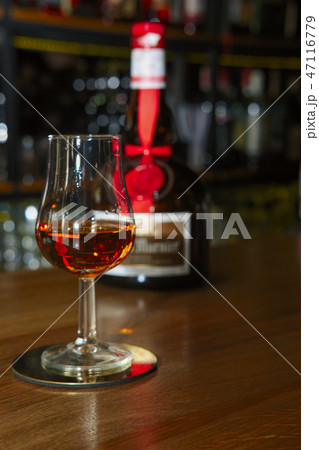 Glass and bottle of liqueur Grand Marnier Glass and bottle of liqueur Grand Marnier 47116779
