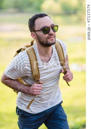 Young man hiking smiling happy portrait. Male hiker walking in forest 47117574