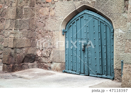 Blue locked gate in old stone wall, Arabic style Blue locked gate in old stone wall, Arabic style 47118397