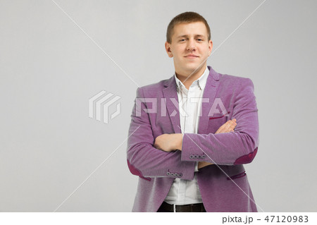 young man in a jacket folded arms isolated on light background 47120983