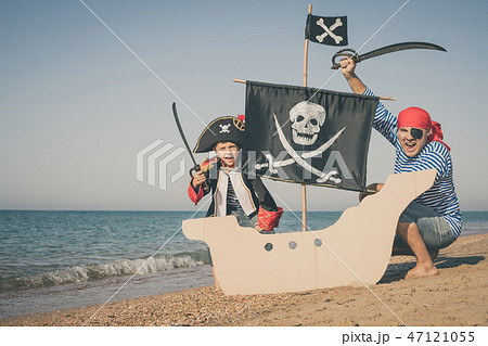 Father and son playing on the beach at the day time. 47121055