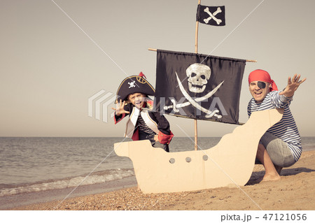 Father and son playing on the beach at the day time. Father and son playing on the beach at the day time. 47121056