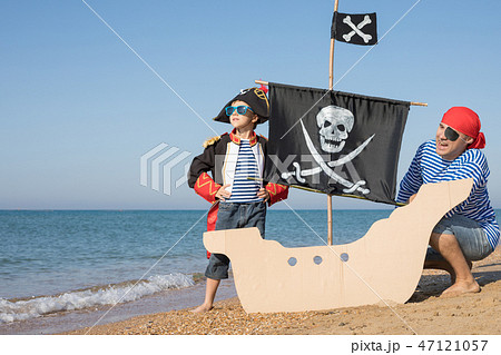 Father and son playing on the beach at the day time. Father and son playing on the beach at the day time. 47121057