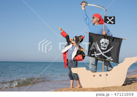 Father and son playing on the beach at the day time. 47121059