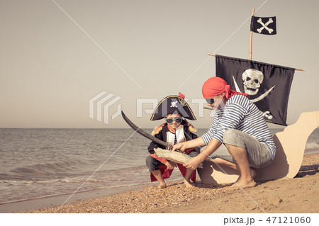 Father and son playing on the beach at the day time. Father and son playing on the beach at the day time. 47121060