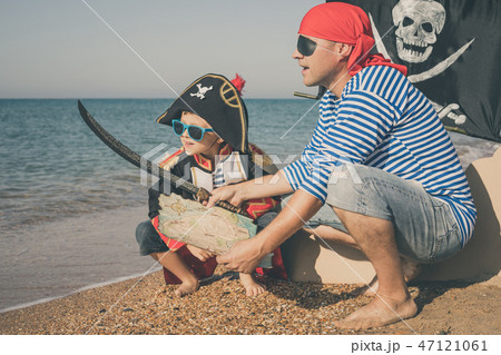 Father and son playing on the beach at the day time. 47121061