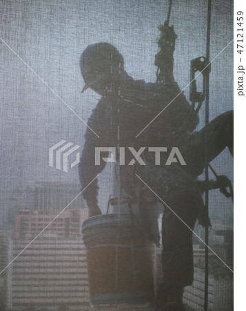 Silhouette images of man cleaning window building 47121459
