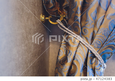 Holder for room curtains. Fragment photo curtain, interior detail, curtain detail close up. 47124383