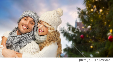 happy couple hugging over christmas tree happy couple hugging over christmas tree 47129502