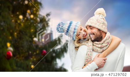 happy couple hugging over christmas tree 47129702