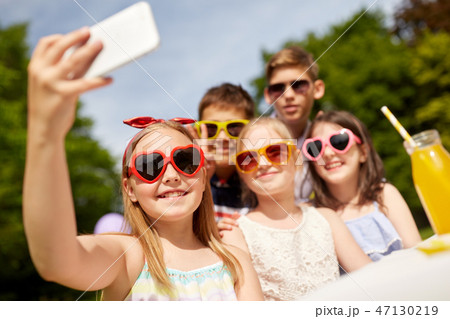 happy kids taking selfie on birthday party 47130219