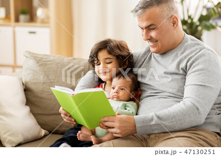 happy father with sons reading book at home happy father with sons reading book at home 47130251