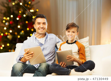 father and son with tablet computers on christmas 47130449