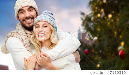 happy couple hugging over christmas tree 47130519