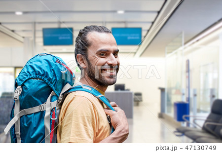 man with backpack over airport terminal 47130749
