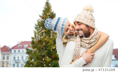 happy couple hugging over christmas tree 47131109