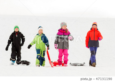happy little kids with sleds in winter happy little kids with sleds in winter 47131190