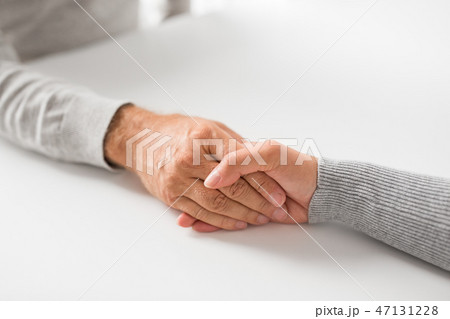 close up of young woman holding senior man hands close up of young woman holding senior man hands 47131228