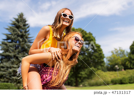 happy teenage girls having fun at summer park 47131317