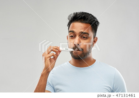 man measuring oral temperature by thermometer man measuring oral temperature by thermometer 47131461
