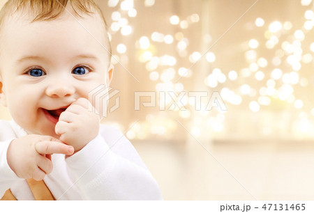 close up of sweet baby over christmas lights close up of sweet baby over christmas lights 47131465